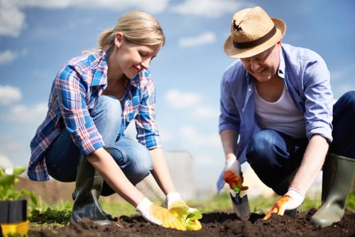 Front view of a gardener inspecting a residential garden