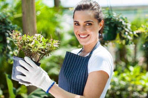 Team of professional gardeners working in a Forest Hill garden with tools